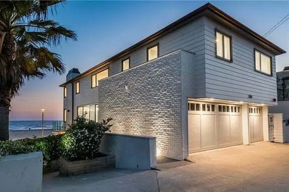 A large white house with a garage door.
