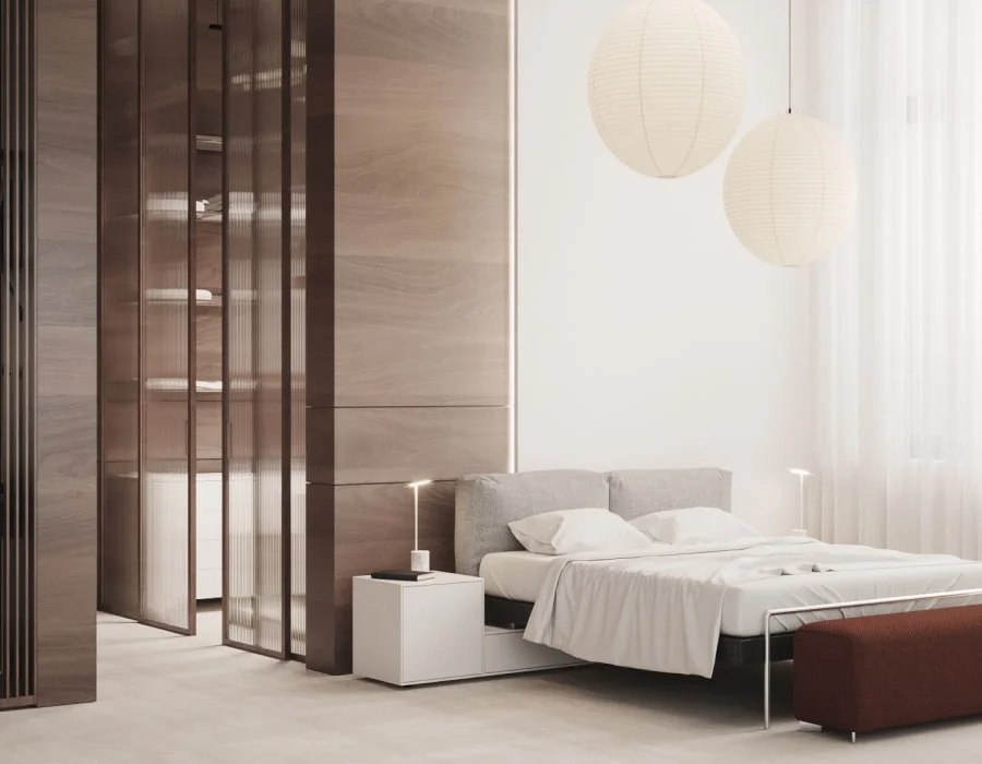 A bedroom with a bed and a chair in it