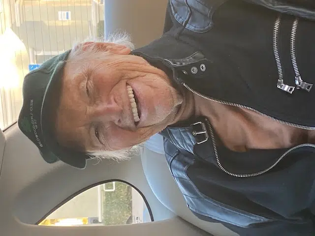 A man sitting in the back of a car.